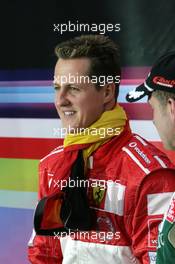 04.12.2004 Paris, France,  Saturday, Michael Schumacher (GER), F1 driver, Scuderia Ferrari, Portrait, with the German flag around his neck - 17th Race of Champions 2004, Stade de France, Paris, France