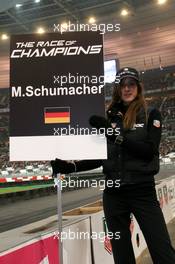 04.12.2004 Paris, France,  Saturday, Grid girl holding the name sign of Michael Schumacher (GER), F1 driver, Scuderia Ferrari - 17th Race of Champions 2004, Stade de France, Paris, France