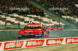 04.12.2004 Paris, France,  Saturday, Marcus Gronholm (FIN), WRC driver, Team Peugeot Sport (front), driving against Mattias Ekstrom (SWE), DTM driver, Team Abt-Audi (rear) - 17th Race of Champions 2004, Stade de France, Paris, France