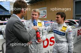 30.04.2005 Klettwitz, Germany,  Mika Häkkinen (FIN), Sport Edition AMG-Mercedes, Portrait (center) and Gary Paffett (GBR), DaimlerChrysler Bank AMG-Mercedes, Portrait (righy), being interviewed for German TV - DTM 2005 at Eurospeedway Lausitzring (Deutsche Tourenwagen Masters)