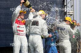 01.05.2005 Klettwitz, Germany,  Podium, Tom Kristensen (DNK), Audi Sport Team Abt, Portrait, spraying champaign in the neck of Mika Häkkinen (FIN), Sport Edition AMG-Mercedes, Portrait - DTM 2005 at Eurospeedway Lausitzring (Deutsche Tourenwagen Masters)