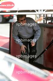 01.05.2005 Klettwitz, Germany,  Norbert Haug (GER), Sporting Director Mercedes-Benz, hiding under the podium for the champaign - DTM 2005 at Eurospeedway Lausitzring (Deutsche Tourenwagen Masters)