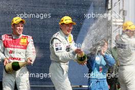 01.05.2005 Klettwitz, Germany,  Mika Häkkinen (FIN), Sport Edition AMG-Mercedes, Portrait (right) and Tom Kristensen (DNK), Audi Sport Team Abt, Portrait (left), spraying champaign - DTM 2005 at Eurospeedway Lausitzring (Deutsche Tourenwagen Masters)