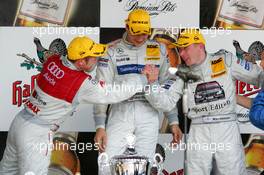 01.05.2005 Klettwitz, Germany,  Podium, Tom Kristensen (DNK), Audi Sport Team Abt, Portrait (2nd), congratulates Mika Häkkinen (FIN), Sport Edition AMG-Mercedes, Portrait (3rd). In the middle: Gary Paffett (GBR), DaimlerChrysler Bank AMG-Mercedes, Portrait (1st) - DTM 2005 at Eurospeedway Lausitzring (Deutsche Tourenwagen Masters)