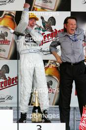 01.05.2005 Klettwitz, Germany,  Podium, Mika Häkkinen (FIN), Sport Edition AMG-Mercedes, Portrait (3rd, left) and Hans-Jürgen Mattheis (GER), Team Manager HWA (right) - DTM 2005 at Eurospeedway Lausitzring (Deutsche Tourenwagen Masters)