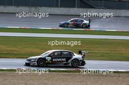 16.09.2005 Klettwitz, Germany,  Rinaldo Capello (ITA), Audi Sport Team Joest, Audi A4 DTM, on the normal circuit while Martin Tomczyk (GER), Audi Sport Team Abt Sportsline, Audi A4 DTM, takes the exit road after missing turn one - DTM 2005 at Lausitzring (Deutsche Tourenwagen Masters)