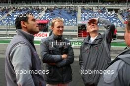 17.09.2005 Klettwitz, Germany,  Dr. Wolfgang Ullrich (GER), Audi's Head of Sport (right) and Hans-Jurgen Abt (GER), Teamchef Abt-Audi (left), check out the weather while chatting with Mattias Ekström (SWE), Audi Sport Team Abt Sportsline, Portrait, before the start of the Super Pole Qualifying - DTM 2005 at Lausitzring (Deutsche Tourenwagen Masters)