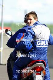18.09.2005 Klettwitz, Germany,  Marcel Fässler (SUI), Opel Performance Center, Portrait, being brought back to the pits on the back of a scooter after retiring from the race due to a collision - DTM 2005 at Lausitzring (Deutsche Tourenwagen Masters)