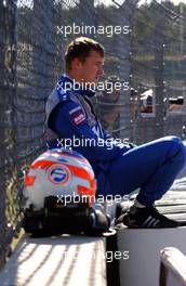 18.09.2005 Klettwitz, Germany,  Marcel Fässler (SUI), Opel Performance Center, Portrait, sitting behind the fence, after retiring from the race due to a collision - DTM 2005 at Lausitzring (Deutsche Tourenwagen Masters)