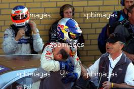 18.09.2005 Klettwitz, Germany,  Mattias Ekström (SWE), Audi Sport Team Abt Sportsline, celebrating his victory with Dr. Wolfgang Ullrich (GER), Audi's Head of Sport. In the background the 2nd placed Gary Paffett (GBR), DaimlerChrysler Bank AMG-Mercedes - DTM 2005 at Lausitzring (Deutsche Tourenwagen Masters)