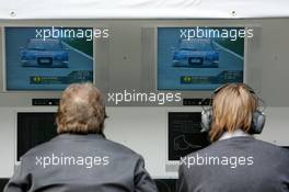 16.04.2005 Hockenheim, Germany,  Norbert Haug (GER), Sporting Director Mercedes-Benz (left) and Hans-Jürgen Mattheis (GER), Team Manager HWA (right), seen on the back, watching Mattias Ekström on a monitor - DTM 2005 at Hockenheimring Baden-Württemberg (Deutsche Tourenwagen Masters)