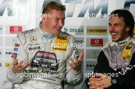 22.10.2005 Hockenheim, Germany,  Mika Häkkinen (FIN), Sport Edition AMG-Mercedes, Portrait (left), and Laurent Aiello (FRA), Opel Performance Center, Portrait (right), laughing about a joke - DTM 2005 at Hockenheimring (Deutsche Tourenwagen Masters)