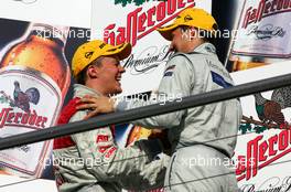 23.10.2005 Hockenheim, Germany,  Podium, Mattias Ekström (SWE), Audi Sport Team Abt Sportsline, Portrait (left), congratulates Gary Paffett (GBR), DaimlerChrysler Bank AMG-Mercedes, Portrait (right), with the championship while both share a laugh - DTM 2005 at Hockenheimring (Deutsche Tourenwagen Masters)