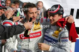 23.10.2005 Hockenheim, Germany,  New 2005 DTM champion Gary Paffett (GBR), DaimlerChrysler Bank AMG-Mercedes, Portrait (right) is handed his championship beer, with Bernd Schneider (GER), Vodafone AMG-Mercedes, Portrait (1st) - DTM 2005 at Hockenheimring (Deutsche Tourenwagen Masters)