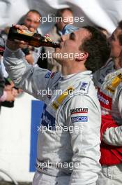23.10.2005 Hockenheim, Germany,  Gary Paffett (GBR), DaimlerChrysler Bank AMG-Mercedes, Portrait, having one of his own championship beers - DTM 2005 at Hockenheimring (Deutsche Tourenwagen Masters)