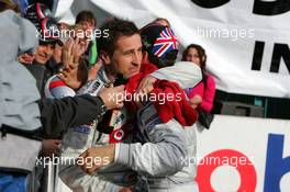 23.10.2005 Hockenheim, Germany,  Race winner Bernd Schneider (GER), Vodafone AMG-Mercedes, Portrait (st), congratulates Gary Paffett (GBR), DaimlerChrysler Bank AMG-Mercedes, Portrait (3rd) with the 2005 DTM championship - DTM 2005 at Hockenheimring (Deutsche Tourenwagen Masters)