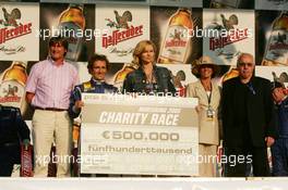 16.07.2005 Nürnberg, Germany,  Podium, Alain Prost (FRA) (1st) and Veronica Ferres (GER), actrice and ambassador of the Power Child charity, with the cheque of 500.000 euro - DTM 2005 Race of the Legends at Norisring (Deutsche Tourenwagen Masters)