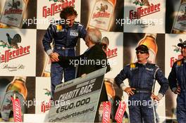 16.07.2005 Nürnberg, Germany,  Podium, Alain Prost (FRA), receives the cheque for 500.000 euro - DTM 2005 Race of the Legends at Norisring (Deutsche Tourenwagen Masters)