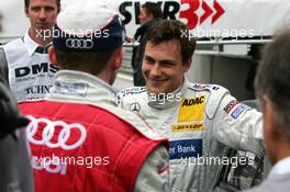 07.08.2005 Nürburg, Germany,  Gary Paffett (GBR), DaimlerChrysler Bank AMG-Mercedes, Portrait, could still smile after the race although he lost the win to Mattias Ekström (SWE), Audi Sport Team Abt Sportsline (seen on the back) due to a drive-through penalty - DTM 2005 at Nürburgring (Deutsche Tourenwagen Masters)