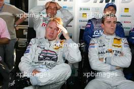 16.07.2005 Nürnberg, Germany,  The Mercedes drivers Bernd Schneider (GER), Vodafone AMG-Mercedes, Portrait (back row), Mika Häkkinen (FIN), Sport Edition AMG-Mercedes, Portrait (front, left) and Jamie Green (GBR), Salzgitter AMG-Mercedes, Portrait (front, right) look dissapointed when they see Gary Paffett not take pole position by just 0.009 seconds - DTM 2005 at Norisring (Deutsche Tourenwagen Masters)