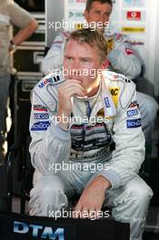 16.07.2005 Nürnberg, Germany,  Mika Häkkinen (FIN), Sport Edition AMG-Mercedes, Portrait, watches the performance of the other drivers on TV - DTM 2005 at Norisring (Deutsche Tourenwagen Masters)