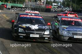 17.07.2005 Nürnberg, Germany,  Laurent Aiello (FRA), Opel Performance Center, Opel Vectra GTS V8 and Gary Paffett (GBR), DaimlerChrysler Bank AMG-Mercedes, AMG-Mercedes C-Klasse, side-by-side exiting the hairpin - DTM 2005 at Norisring (Deutsche Tourenwagen Masters)