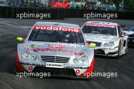 17.07.2005 Nürnberg, Germany,  Bernd Schneider (GER), Vodafone AMG-Mercedes, AMG-Mercedes C-Klasse, leads Bruno Spengler (CDN), Junge Gebrauchte von Mercedes, AMG-Mercedes C-Klasse - DTM 2005 at Norisring (Deutsche Tourenwagen Masters)