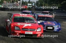 17.07.2005 Nürnberg, Germany,  Heinz-Harald Frentzen (GER), Opel Performance Center, Opel Vectra GTS V8 and Martin Tomczyk (GER), Audi Sport Team Abt Sportsline, Audi A4 DTM, side-by-side exiting the hairpin - DTM 2005 at Norisring (Deutsche Tourenwagen Masters)