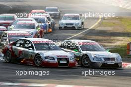 17.07.2005 Nürnberg, Germany,  Start of the race, with Tom Kristensen (DNK), Audi Sport Team Abt, Audi A4 DTM (left) and Gary Paffett (GBR), DaimlerChrysler Bank AMG-Mercedes, AMG-Mercedes C-Klasse (right), going into the first corner side-by-side - DTM 2005 at Norisring (Deutsche Tourenwagen Masters)