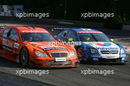 17.07.2005 Nürnberg, Germany,  Alexandros Margaritis (GRC), Mücke Motorsport, AMG-Mercedes C-Klasse (left) and Manuel Reuter (GER), Opel Performance Center, Opel Vectra GTS V8, side-by-side - DTM 2005 at Norisring (Deutsche Tourenwagen Masters)