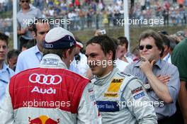 26.06.2005 Oschersleben, Germany,  Mattias Ekström (SWE), Audi Sport Team Abt Sportsline, Portrait (2nd, left), chatting with Gary Paffett (GBR), DaimlerChrysler Bank AMG-Mercedes, Portrait (1st, center). Right, in the background: Norbert Haug (GER), Sporting Director Mercedes-Benz - DTM 2005 at Motopark Oschersleben (Deutsche Tourenwagen Masters)