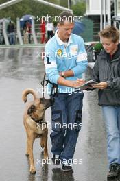 11.09.2005 Spa-Francorchamps, Belgium, Michael Schumacher, GER, Ferrari signs a autograph whilt with his dog Shiva - September, Formula 1 World Championship, Rd 16, Belgian Grand Prix