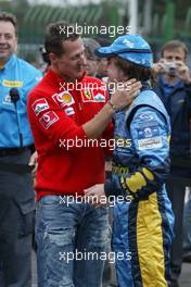 25.09.2005 Sao Paulo, Brazil,  Michael Schumacher, GER, Ferrari congratulates Fernando Alonso, ESP, Renault F1 Team for winning the World Championship - September, Formula 1 World Championship, Rd 17, Brazilian Grand Prix, Sunday Podium