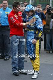 25.09.2005 Sao Paulo, Brazil,  Michael Schumacher, GER, Ferrari congratulates Fernando Alonso, ESP, Renault F1 Team for winning the World Championship - September, Formula 1 World Championship, Rd 17, Brazilian Grand Prix, Sunday Podium