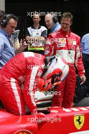 11.06.2005 Montreal, Canada,  Michael Schumacher, GER, Ferrari looks down on Rubens Barrichello, BRA, Ferrari, who failed to make a Qualifying lap- June, Formula 1 World Championship, Rd 8, Canadian Grand Prix, Montreal, CDN, Qualifying