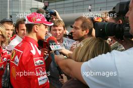 16.10.2005 Shanghai, China,  Michael Schumacher, GER, Ferrari talks with the media after crashing out of the Chinese race - October, Formula 1 World Championship, Rd 19, Chinese Grand Prix, Sunday Race