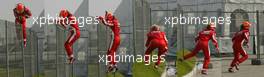 16.10.2005 Shanghai, China,  PHOTO MONTAGE, Combo - Michael Schumacher, GER, Ferrari climbs a fence before running back to the pits after crashing during the Installation lap - October, Formula 1 World Championship, Rd 19, Chinese Grand Prix, Sunday Race