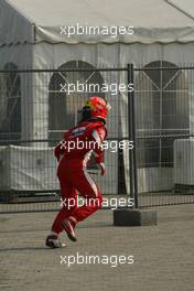 16.10.2005 Shanghai, China,  Michael Schumacher, GER, Ferrari climbs a fence before running back to the pits after crashing during the Installation lap - October, Formula 1 World Championship, Rd 19, Chinese Grand Prix, Sunday Race