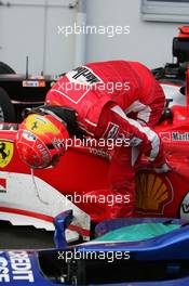 29.05.2005 Nuerburg, Germany,  Michael Schumacher (GER), Scuderia Ferrari Marlboro, getting out of the car in the Parc Ferme and looks under the car - May, Formula 1 World Championship, Rd 7, European Grand Prix, Nürburgring, GER, Podium