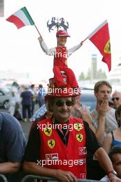 26.05.2005 Nuerburg, Germany,  Fan of Michael Schumacher (GER), Scuderia Ferrari Marlboro, with a large hat with a doll of Michael Schumacher holding the Italian and a Ferrari flag - May, Formula 1 World Championship, Rd 7, European Grand Prix, Nürburgring, GER