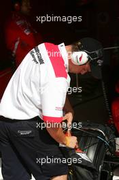01.07.2005 Magny-Cours, France,  A Bridgestone tyre engineer measuring the tyre temperature of one of the tyres - July, Formula 1 World Championship, Rd 10, French Grand Prix, Magny Cours, France, Practice