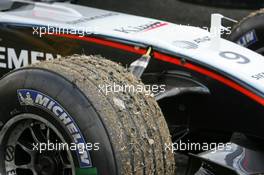 01.07.2005 Magny-Cours, France,  Gras and stones on the tyres of Kimi Raikkonen (FIN), West McLaren Mercedes MP4-20, after stopping on the track - July, Formula 1 World Championship, Rd 10, French Grand Prix, Magny Cours, France, Practice