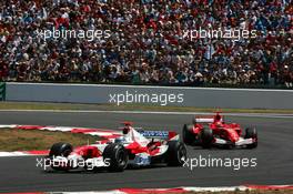 03.07.2005 Magny-Cours, France,  Jarno Trulli (ITA), Panasonic Toyota Racing TF105, leads Michael Schumacher (GER), Scuderia Ferrari Marlboro F2005 - July, Formula 1 World Championship, Rd 10, French Grand Prix, Magny Cours, France, Race