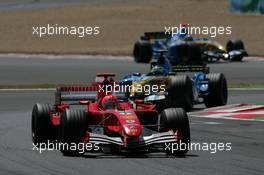 03.07.2005 Magny-Cours, France,  Michael Schumacher, GER, Scuderia Ferrari Marlboro, F2005, Action, Track leads Giancarlo Fisichella, ITA, Mild Seven Renault F1 Team, R25, Action, Track - July, Formula 1 World Championship, Rd 10, French Grand Prix, Magny Cours, France, Race