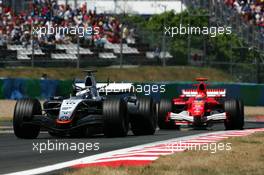 03.07.2005 Magny-Cours, France,  Juan-Pablo Montoya (COL), West McLaren Mercedes MP4-20, leads Michael Schumacher (GER), Scuderia Ferrari Marlboro F2005 - July, Formula 1 World Championship, Rd 10, French Grand Prix, Magny Cours, France, Race