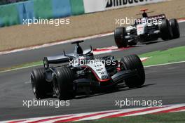 03.07.2005 Magny-Cours, France,  Juan-Pablo Montoya, COL, Juan Pablo, West McLaren Mercedes, MP4-20, Action, Track leads Jenson Button, GBR, Lucky Strike BAR Honda 007, Action, Track - July, Formula 1 World Championship, Rd 10, French Grand Prix, Magny Cours, France, Race