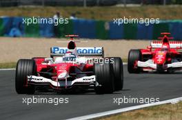 03.07.2005 Magny-Cours, France,  Jarno Trulli (ITA), Panasonic Toyota Racing TF105, leads Michael Schumacher (GER), Scuderia Ferrari Marlboro F2005 - July, Formula 1 World Championship, Rd 10, French Grand Prix, Magny Cours, France, Race