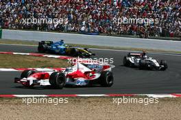 03.07.2005 Magny-Cours, France,  Jarno Trulli (ITA), Panasonic Toyota Racing TF105, leads Jenson Button (GBR), Lucky Strike BAR Honda 007 and Giancarlo Fisichella (ITA), Mild Seven Renault F1 R25 - July, Formula 1 World Championship, Rd 10, French Grand Prix, Magny Cours, France, Race
