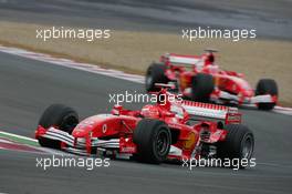 02.07.2005 Magny-Cours, France,  Michael Schumacher, GER, Scuderia Ferrari Marlboro, F2005, Action, Track leads Rubens Barrichello, BRA, Ferrari - July, Formula 1 World Championship, Rd 10, French Grand Prix, Magny Cours, France, Practice