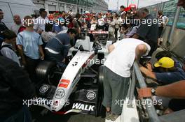 30.06.2005 Magny-Cours, France,  Fans looking at one of the BAR cars from real close during the Thursday afternoon pitwalk when the car is waiting to go to technical scruteneering - June, Formula 1 World Championship, Rd 10, French Grand Prix, Magny Cours, France